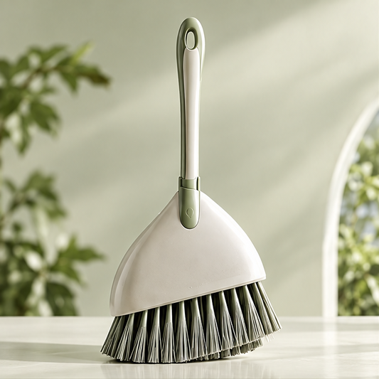 Cream-and-green broom with dense bristles shown without text