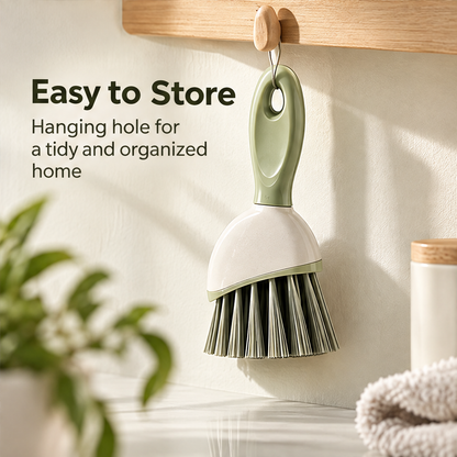 Sage green hand brush used with suds beside a sink